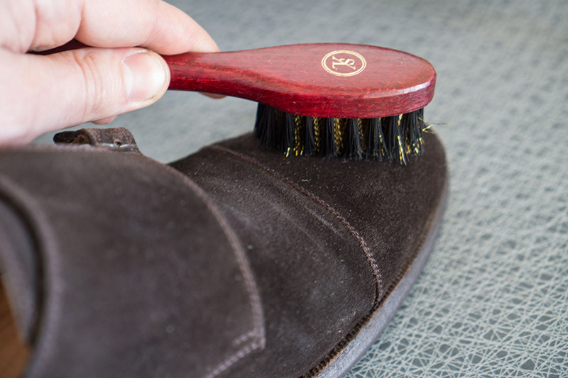 برس را با فشار به سطح کفش جیر بکشید تا خراش‌ها و ردهای سطح کفش از بین بروند.